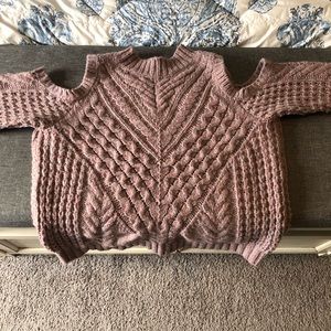 Express cropped sweater with shoulder cutouts.